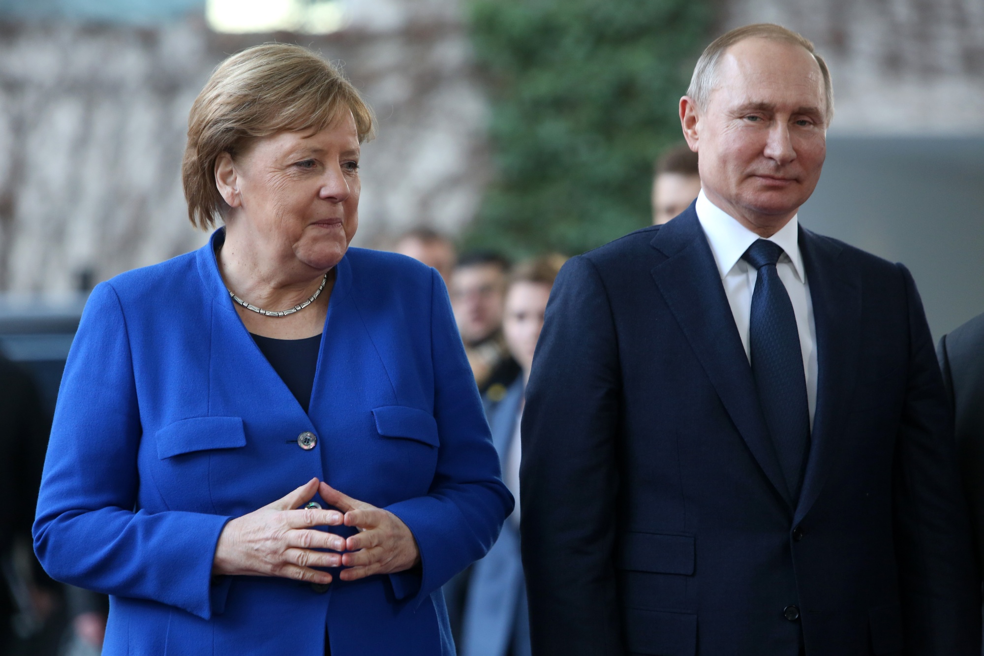 German Chancellor Angela Merkel greets Russian President Vladimir Putin as he arrives for an international summit on securing peace in Libya on Jan. 19, 2020 in Berlin.