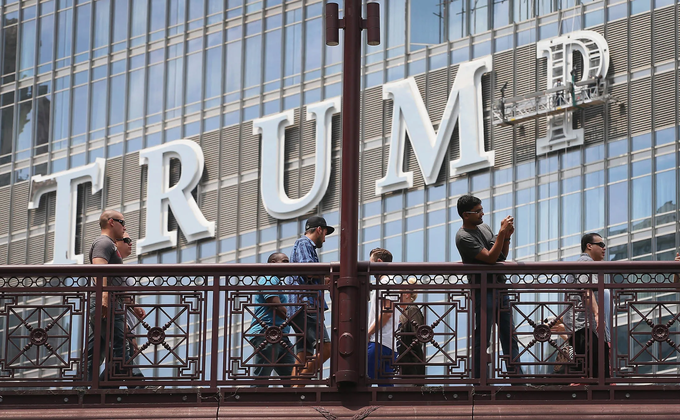 Workers install the final letter for a giant TRUMP sign on the outside of the Trump Tower in Chicago in June 2014.
