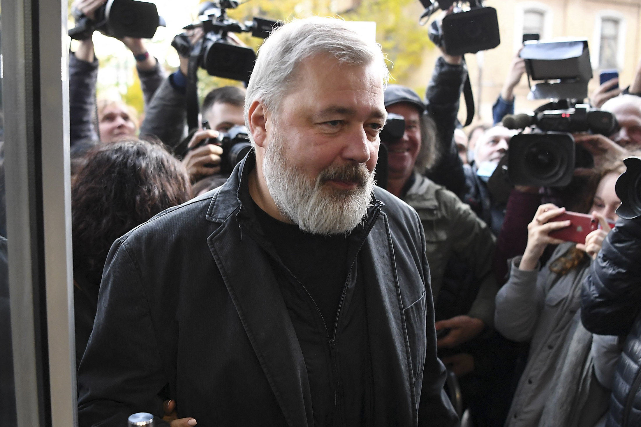 Dmitry Muratov meets with reporters outside the newspaper's office in Moscow on Oct.&nbsp;8, 2021.