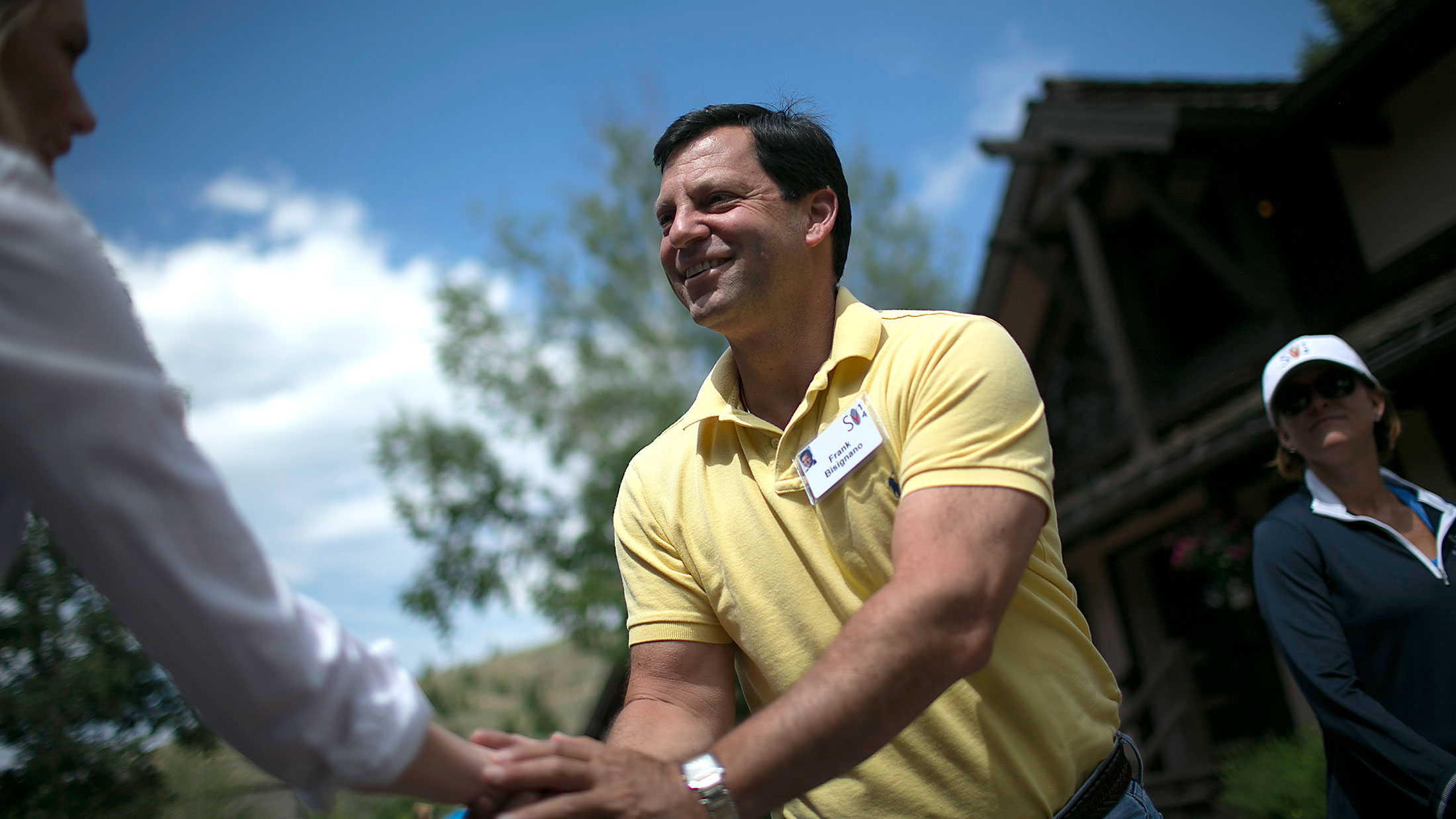 Frank Bisignano, chief executive officer of First Data Corp., shakes a reporter's hand on the grounds during the Allen &amp; Co. Media and Technology Conference in Sun Valley, Idaho, on July 9, 2014.

