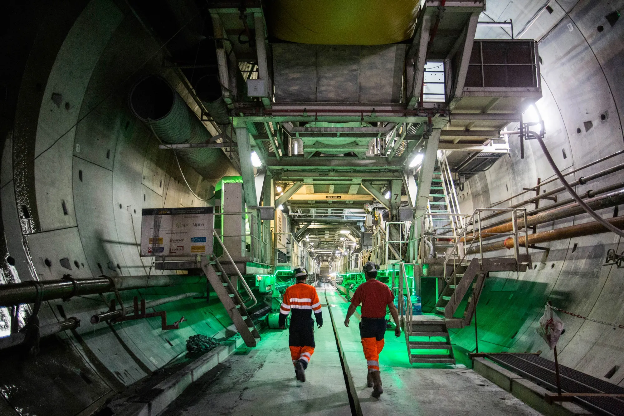Workers inspect the tunnel boring machine at the Telt construction site in Saint Martin de la Porte, France.