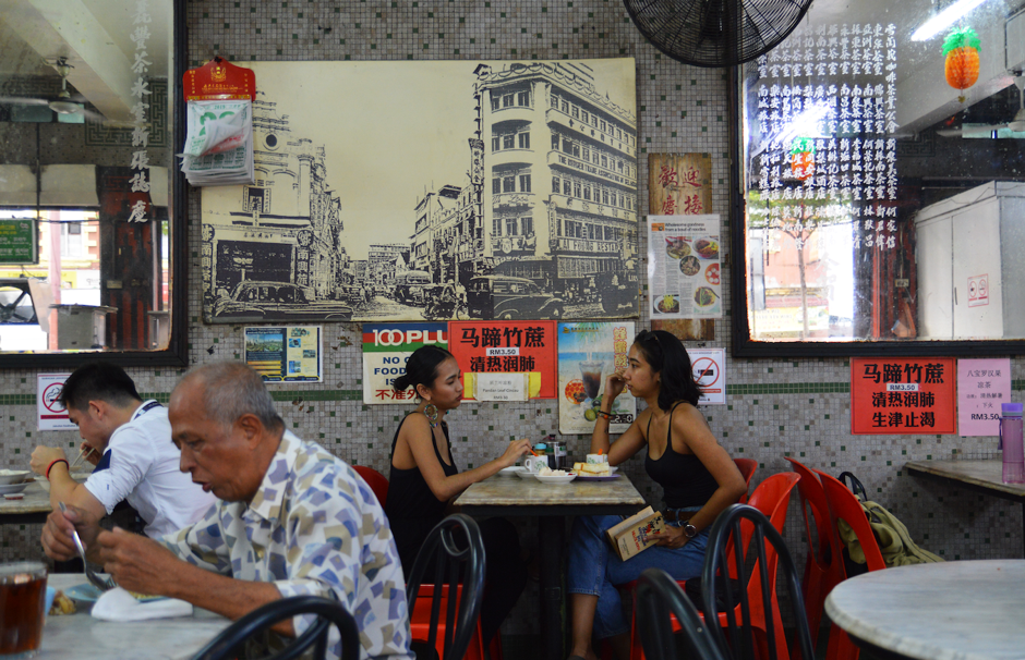 Patrons in a traditional coffeehouse in Kuala Lumpur.
