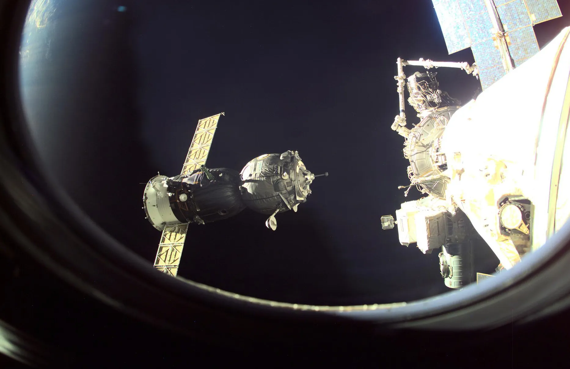 A Russian Soyuz spacecraft approaches the International Space Station delivering a crew of three for an eight-day stay in 2001.