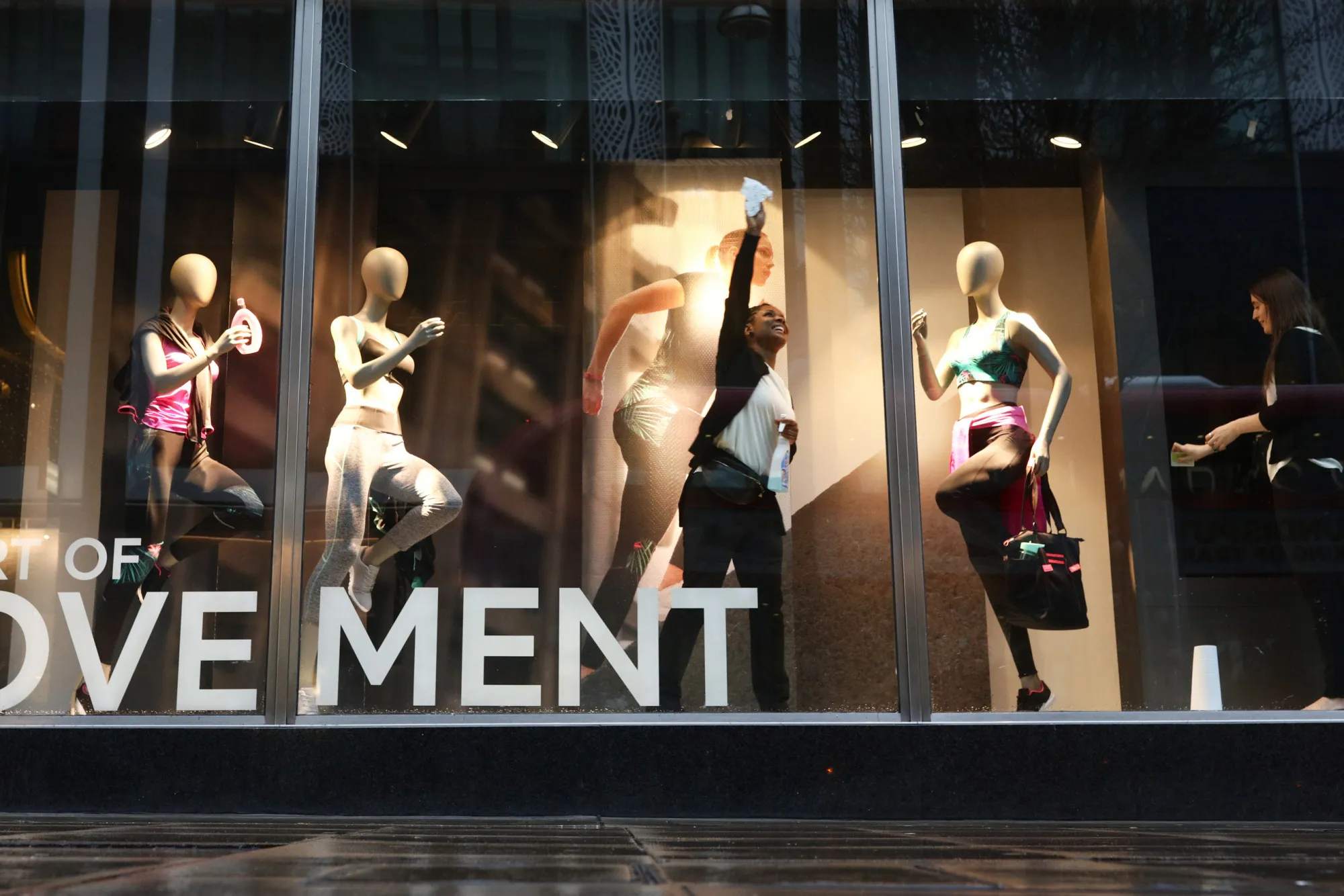A employee cleans the display window at a Marks And Spencer Plc store on Oxford Street.
