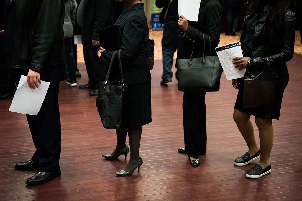 Job seekers wait in line to speak with representatives during a Choice Career Fair in New York.