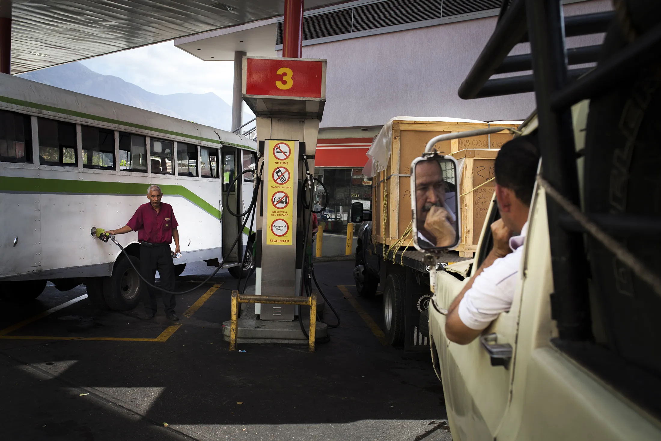 Customers refuel their vehicles at a Petroleos de Venzuela SA (PDVSA) gas station in Caracas, Venezuela on Feb. 11, 2016.
