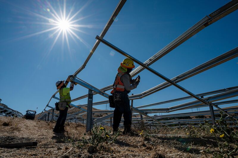 Contractors build frames for solar panels in California.