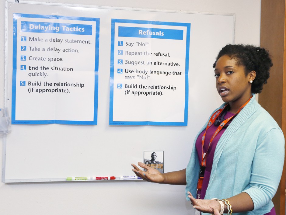 Educator LaNita Harris explains posters used by the Oklahoma City County Health Department in their Teen Pregnancy Prevention program.