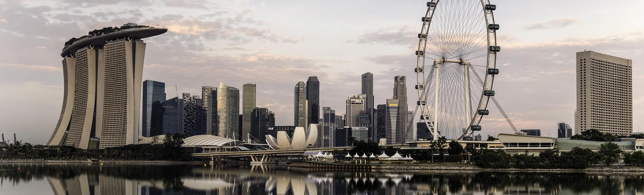 Singapore skyline at dawn, showing the Marina Bay Sands and the Flyer.