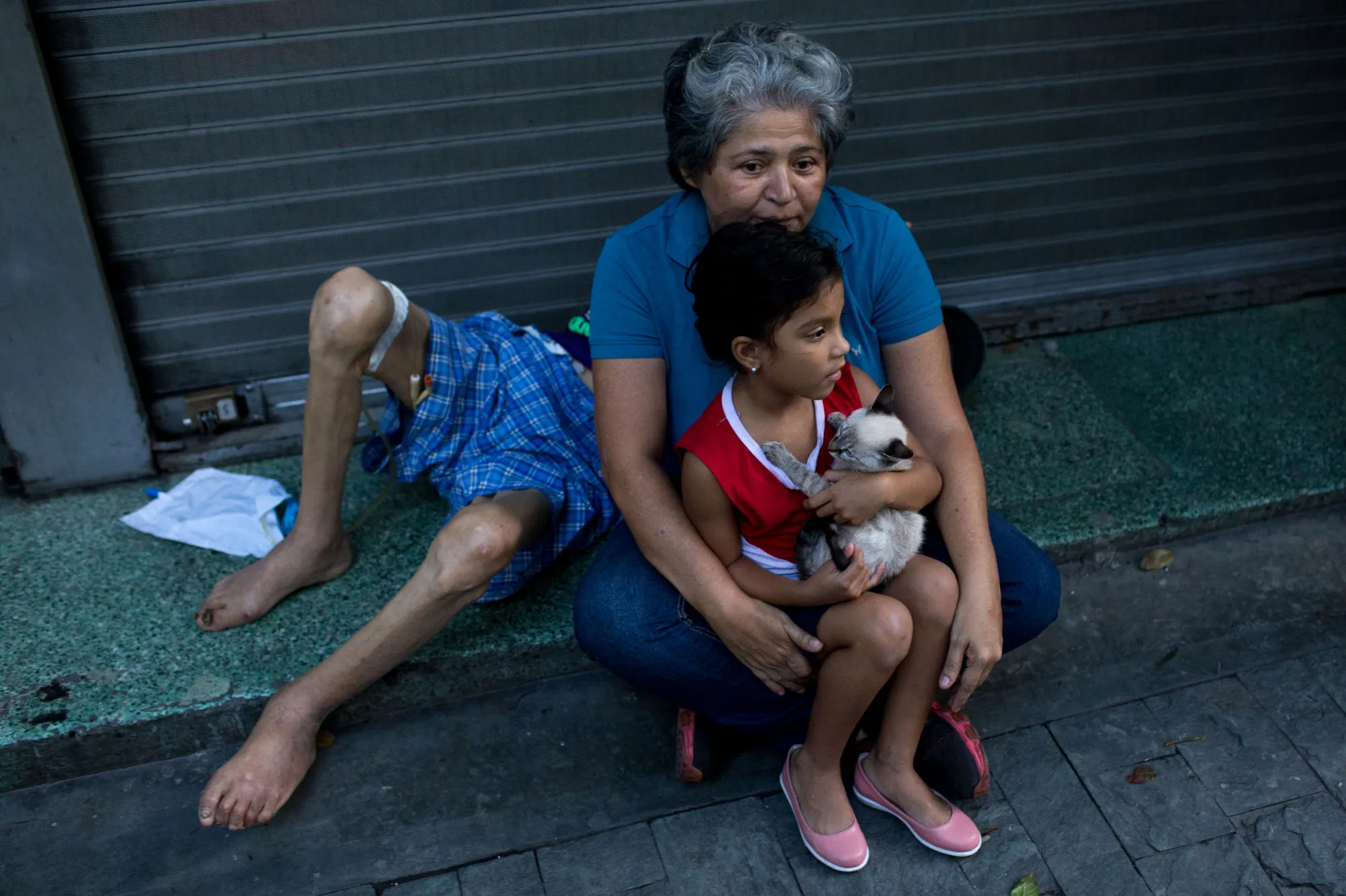 A woman holds a child outside of a building following tremors from an earthquake in Caracas&nbsp;on&nbsp;Aug. 21.