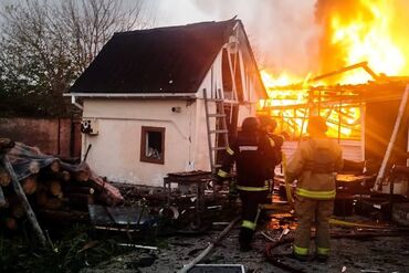 Firefighters at the site of a Russian attack in Kyiv region, in a photo released on Oct. 22.