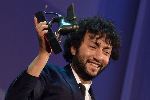 Kaan Mujdeci holds the Special Jury Prize at the 71st Venice Film Festival.