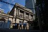 People enter the Bank of Japan (BOJ) headquarters in Tokyo, Japan, on Wednesday, Sept. 13, 2017. The BOJ's next monetary policy meeting is scheduled for Sept. 21. The central bank pushed back in July the projected timing for reaching its 2 percent inflation target for the sixth time as economic growth failed to drive price gains.
