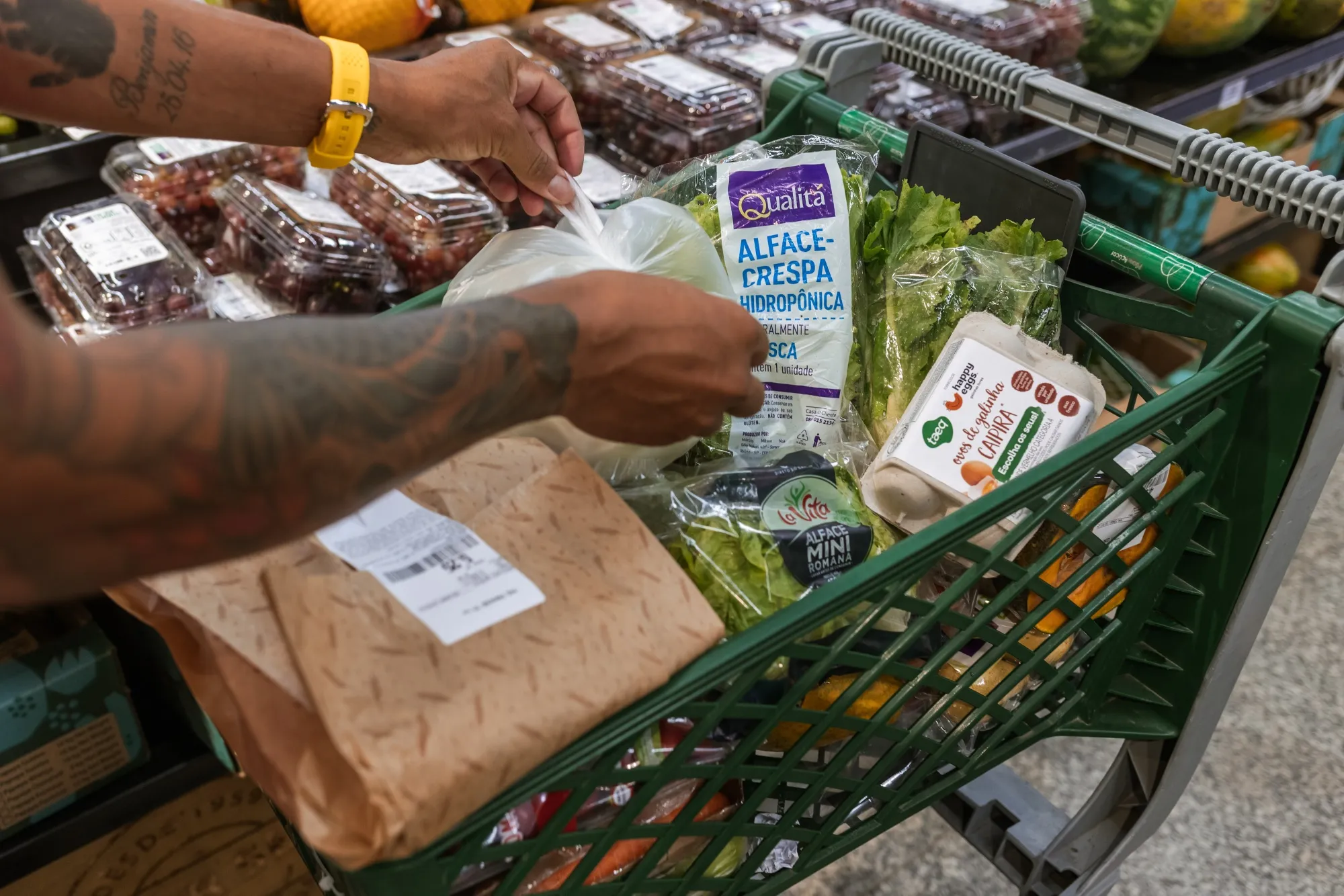 A shopper packs a cart of goods at a&nbsp;grocery store in Sao Paulo, Brazil.