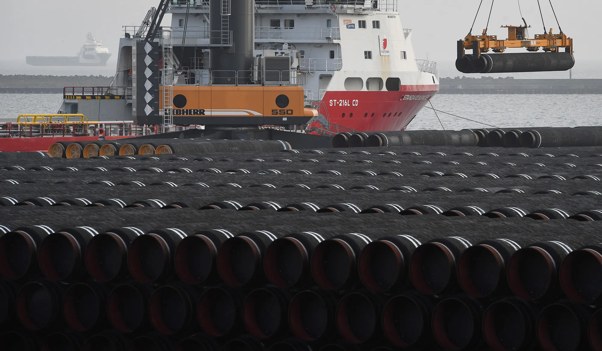 Tubes for the construction of the Nord Stream 2 pipeline are being loaded on a ship in 2019.&nbsp;