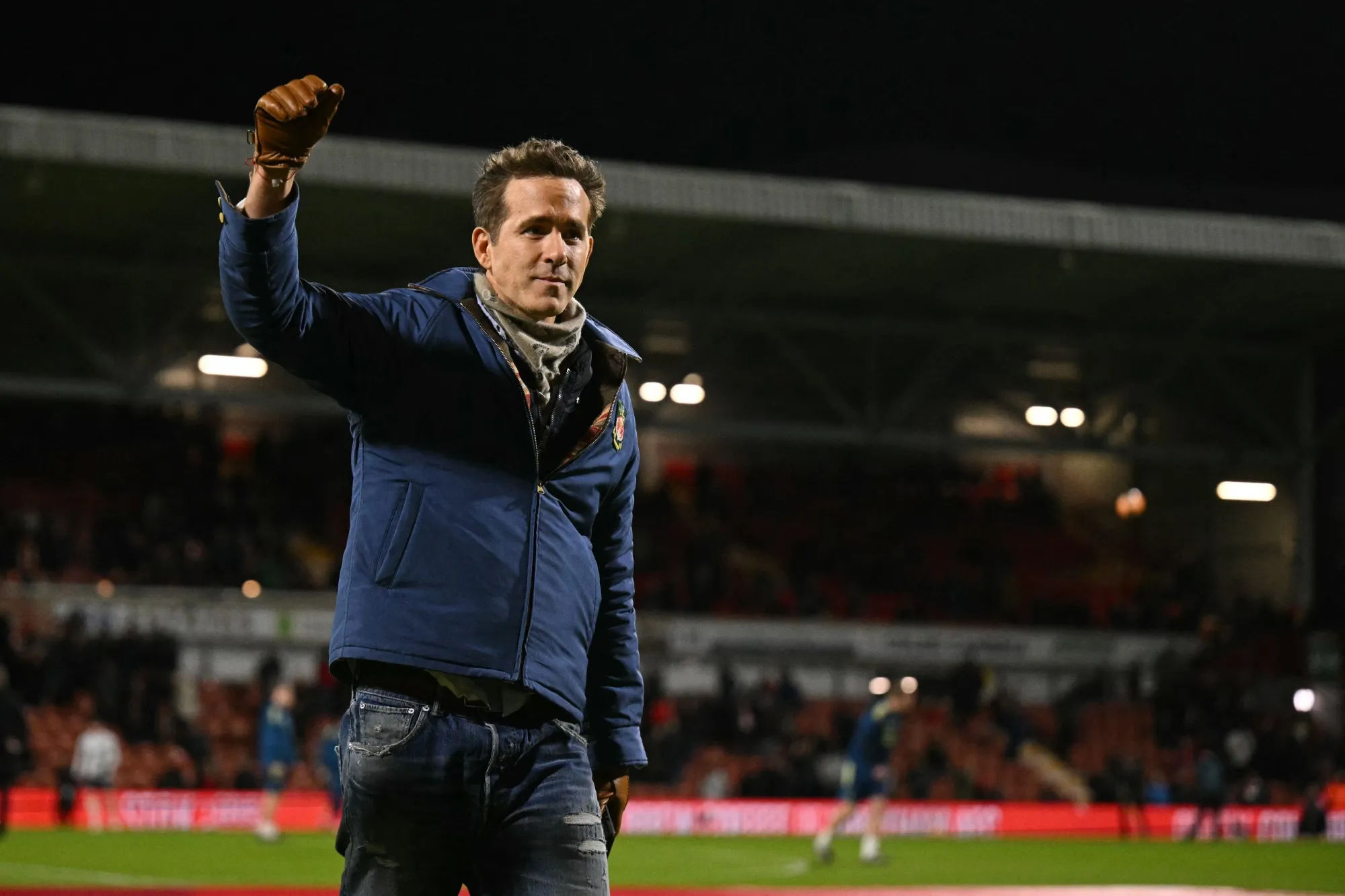 Ryan Reynolds waves to fans as he walks on the pitch before a Wrexham AFC game&nbsp;at the Racecourse Ground Stadium in Wrexham, Wales.