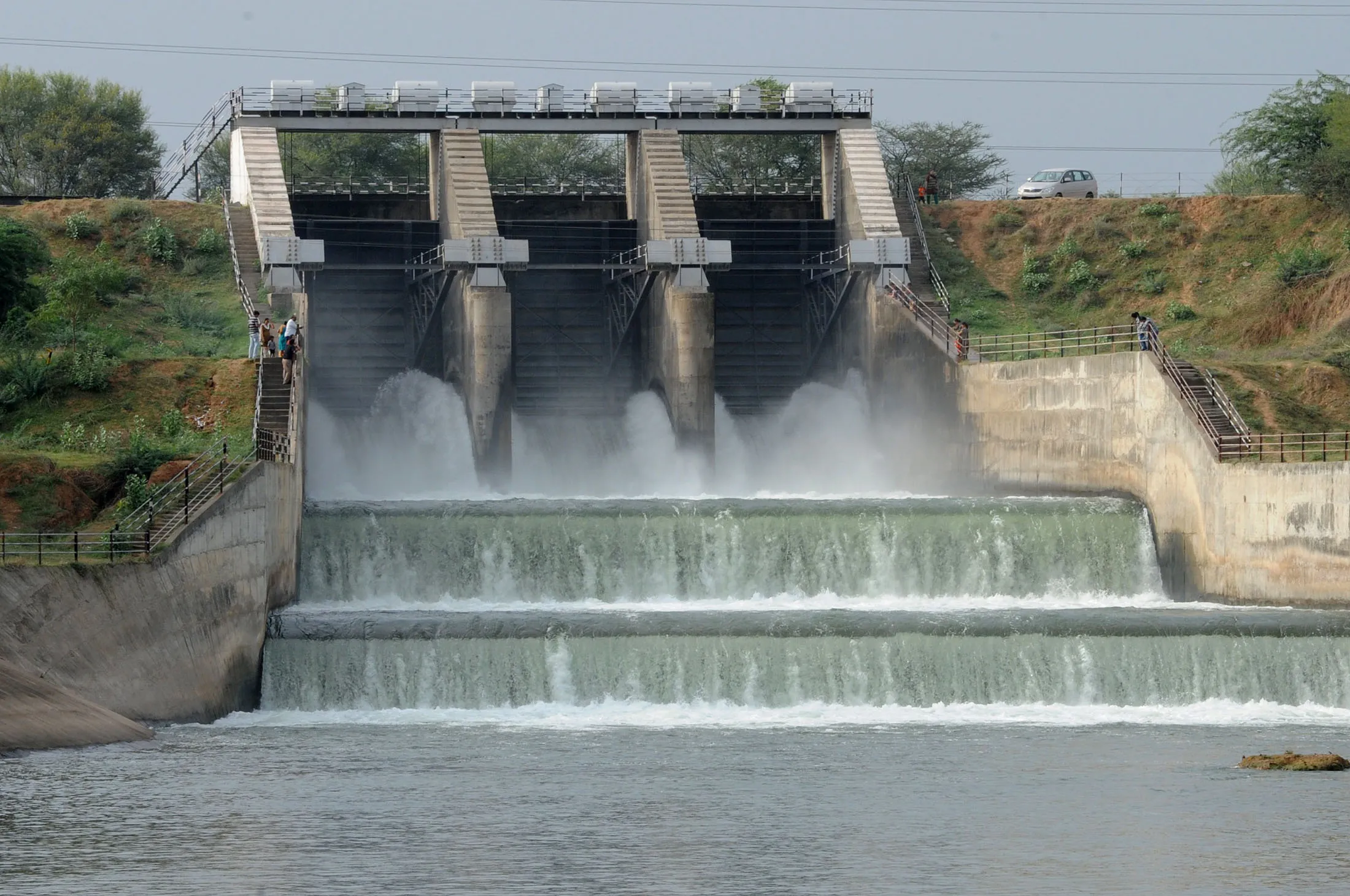 Indian visitors look at water flowing out of Narmada canal from the dam at Karai village of Gandhinagar district, some 30 Kms from Ahmedabad on August 9, 2012.&nbsp;