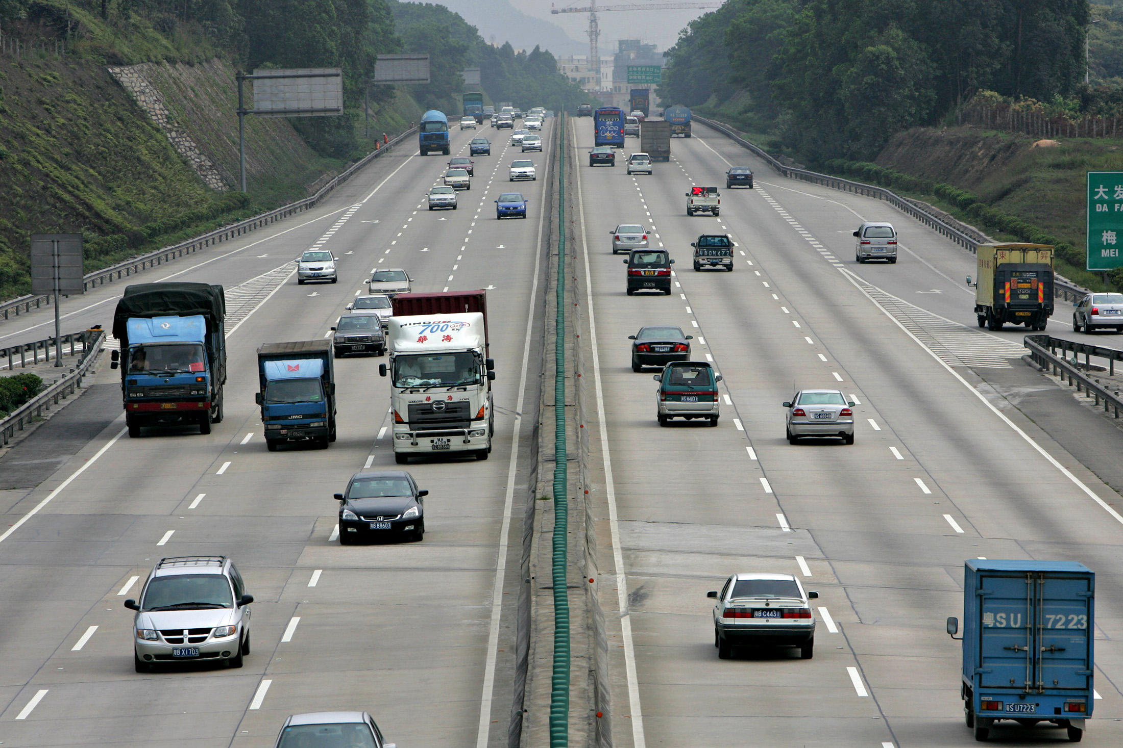 Cars drive on a Shenzhen Expressway Co. highway in Shenzhen, Guangdong Province, China, on March 31, 2006.
