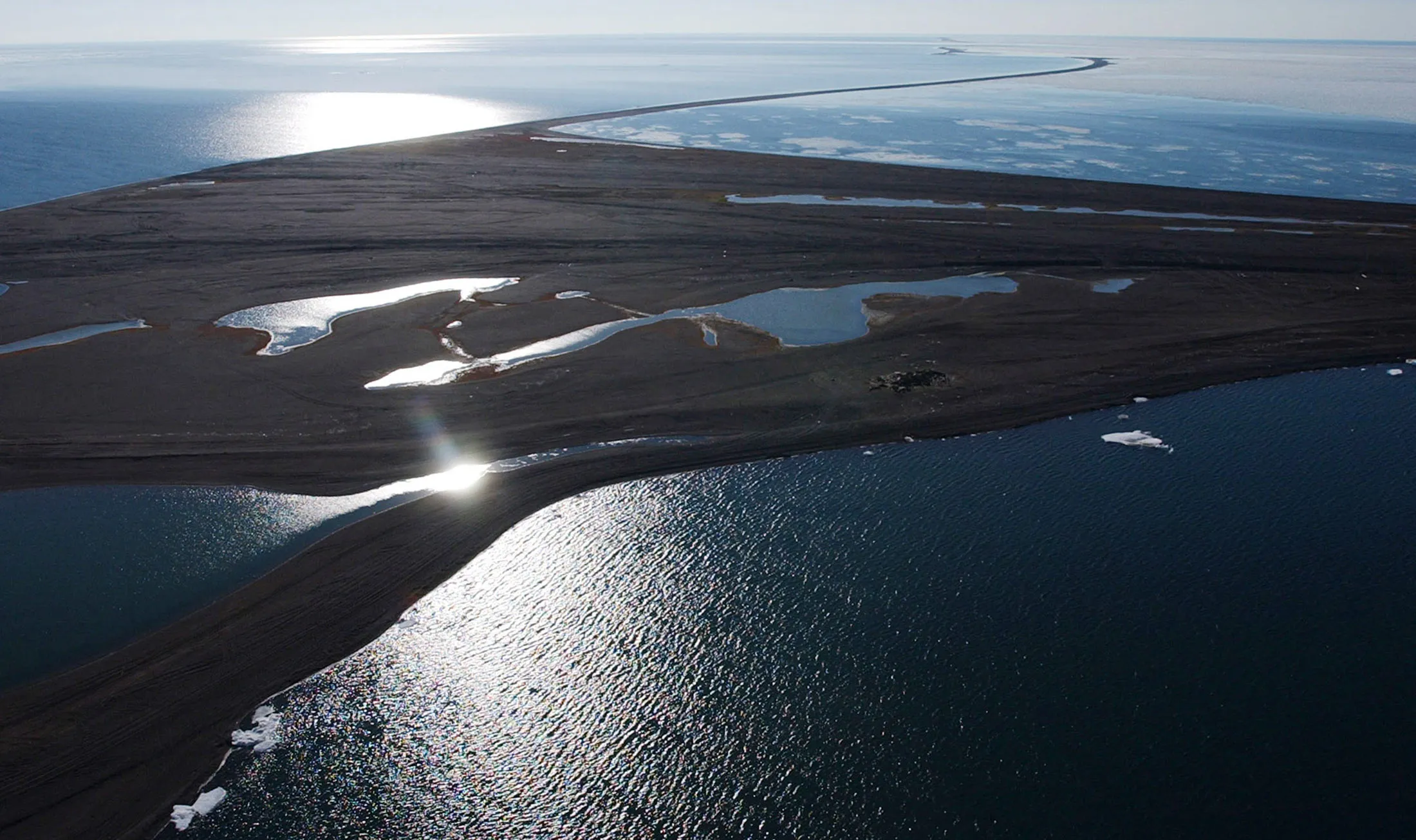 The sun shines on Point Barrow, Alaska, and the Arctic Ocean at the northern tip of the United States, July 16, 2002.
