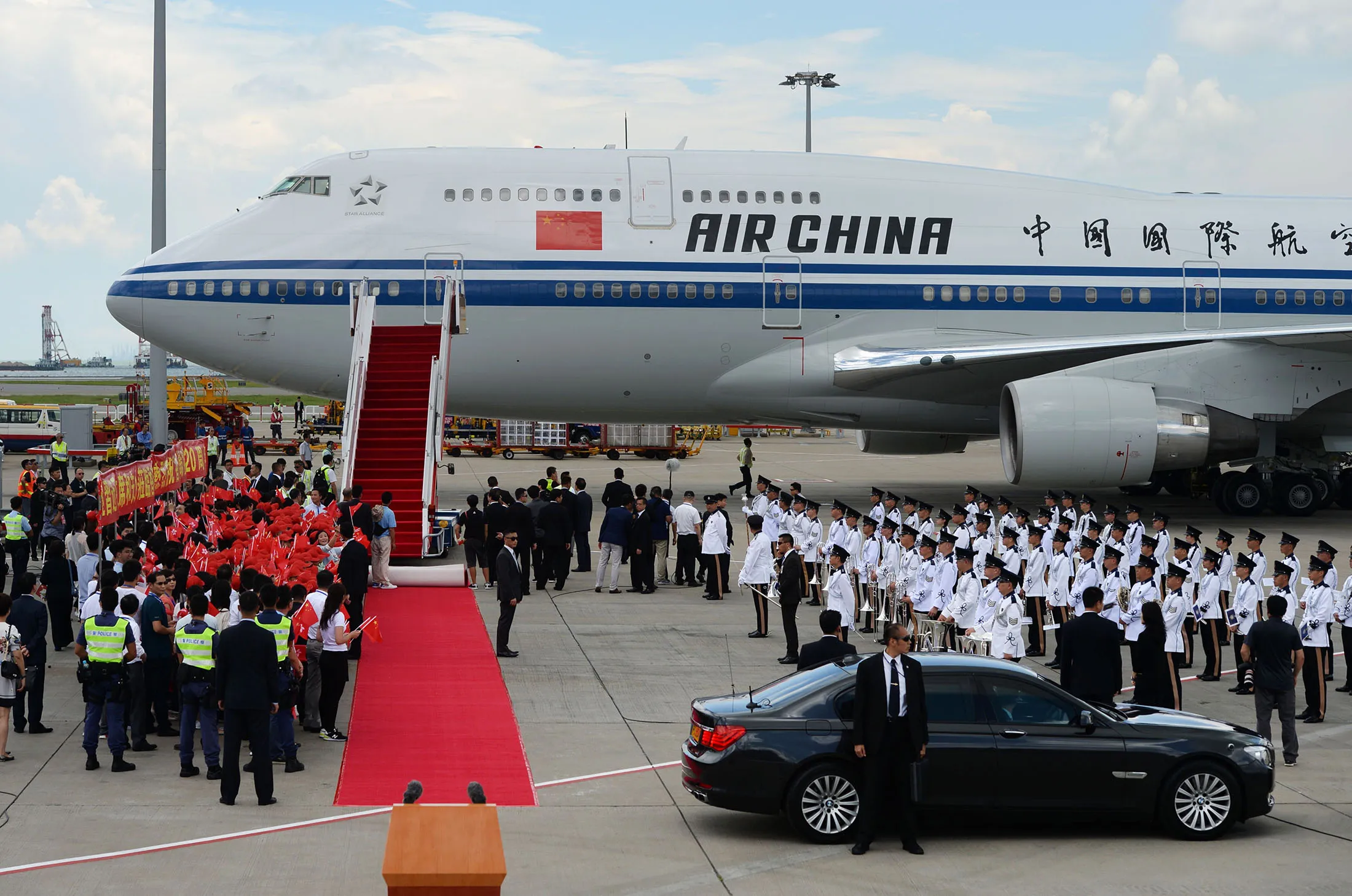 Officials and military personnel (R) wait for China's President Xi Jinping to disembark following his arrival at Hong Kong's international airport on June 29, 2017. Xi arrived in Hong Kong on June 29 to mark 20 years since it was handed back to China by Britain, with leading democracy activists already in police custody after a protest in the politically divided city. / AFP PHOTO / Anthony WALLACE (Photo credit should read ANTHONY WALLACE/AFP/Getty Images)
