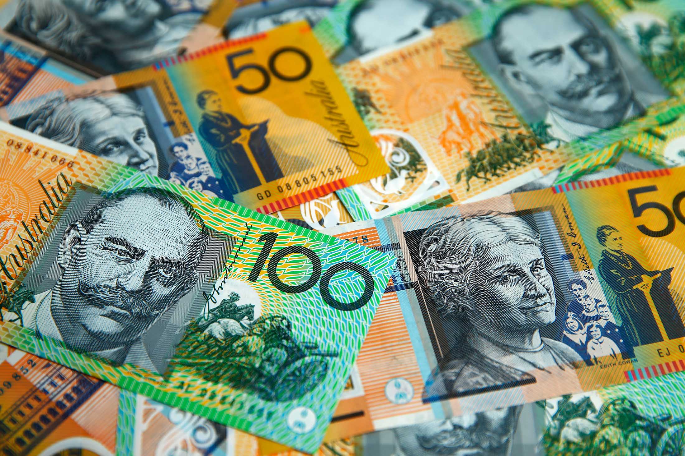 Australian one-hundred dollar and fifty dollar banknotes are arranged for a photograph in Sydney, Australia, on Monday, July 4, 2016. Australia's failure to make a decisive political choice coupled with ongoing Brexit fallout point to the central bank waiting a month to assess the implications before resuming interest-rate cuts.
