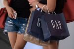 A shopper carries Gap Inc. shopping bags in&nbsp;Hong Kong.