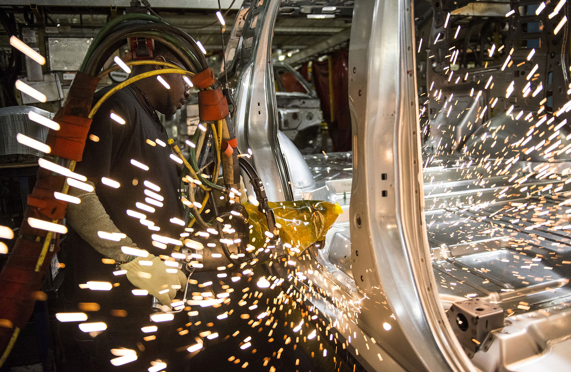 An employee welds together a frame for a sports utility vehicle (SUV) during production at the General Motors Co. (GM) assembly plant in Arlington, Texas, U.S., on Thursday, March 10, 2016. The U.S. Census Bureau is scheduled to release business inventories figures on March 15.
