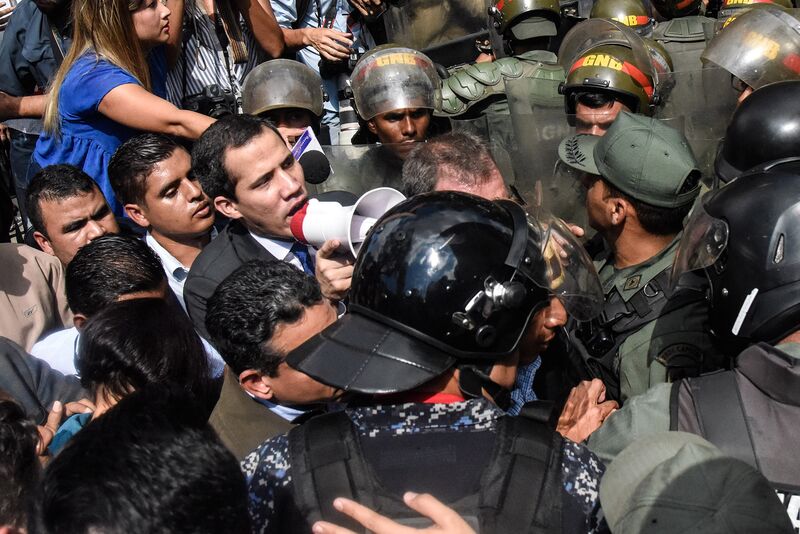 Juan Guaido speaks with a megaphone to the crowd as he attempts to enter the National Assembly in Caracas on Jan. 7, 2020.