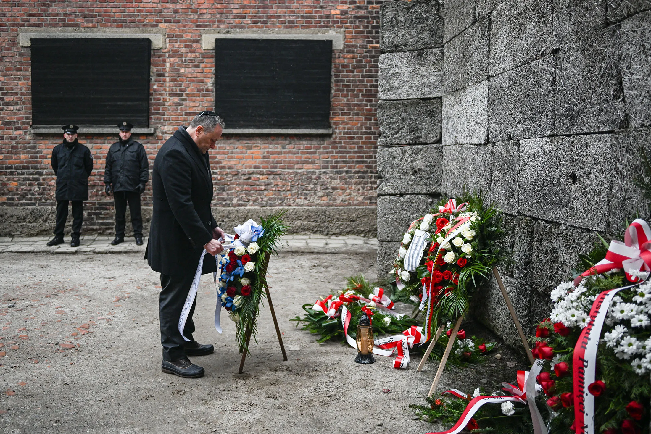 Second Gentleman Doug&nbsp;Emhoff lays wreaths honoring victims of the Nazi regime by the death wall during the Holocaust Remembrance Day at the former Auschwitz I site&nbsp;in Oswiecim, Poland, on Jan.&nbsp;27.
