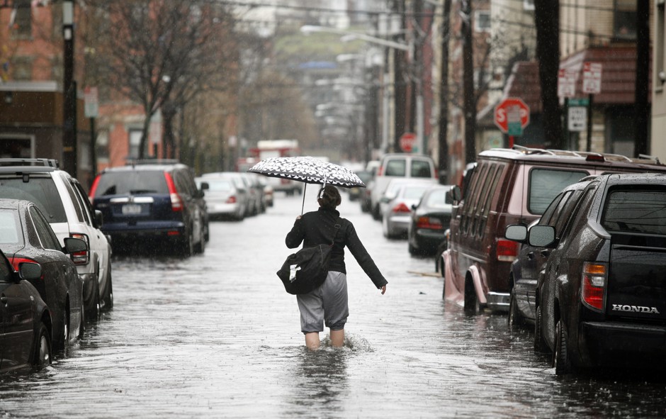 A person walks down a flooded street in Hoboken, New Jersey.