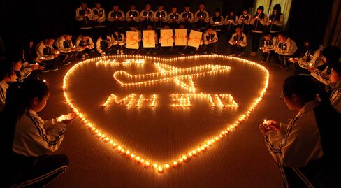 This picture taken on March 10, 2014 shows students at Hailiang International School lighting candles to pray for the passengers on the missing Malaysia Airlines flight MH370 in Zhuji, in China's Zhejiang province.