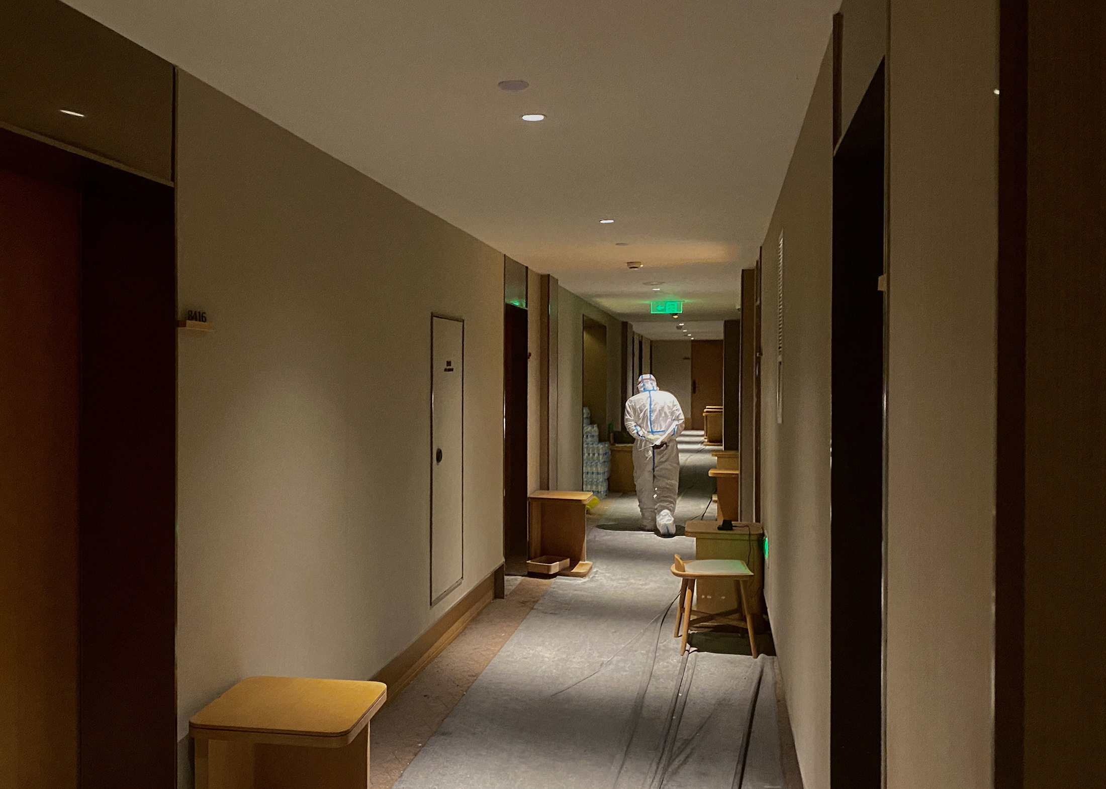 A member of hotel staff walks along a hallway of a quarantine-designated hotel in Shanghai in June. 