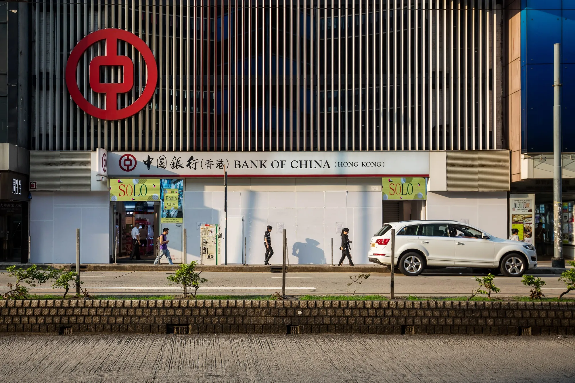 Pedestrians walk past a Bank of China Ltd. branch in&nbsp;Hong Kong.
