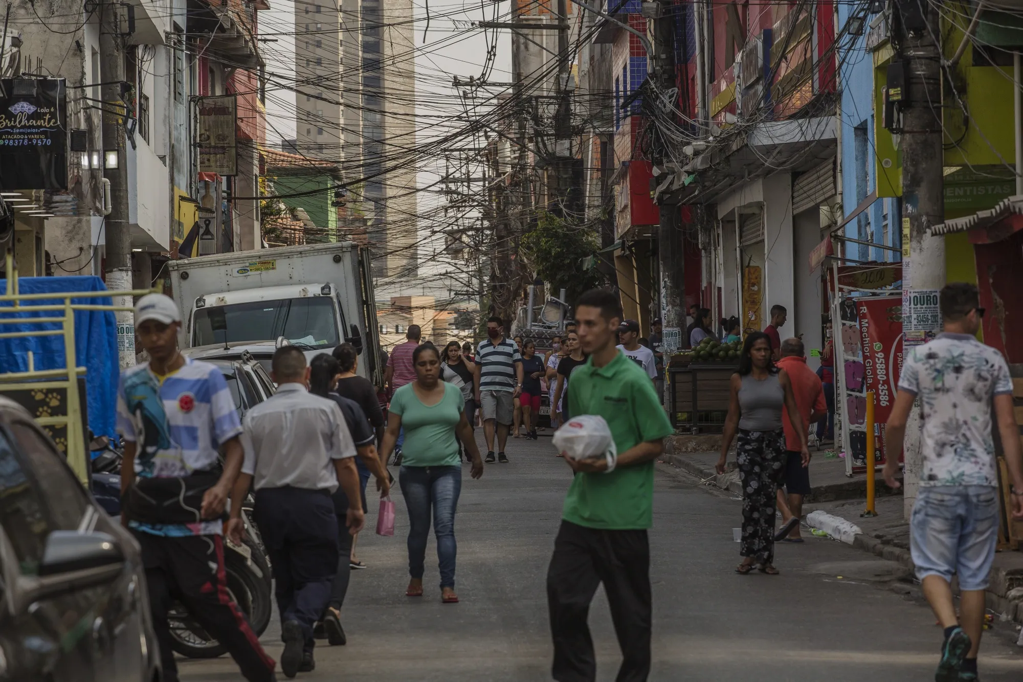 Pedestrians walk through the Paraisopolis favela of Sao Paulo, Brazil.