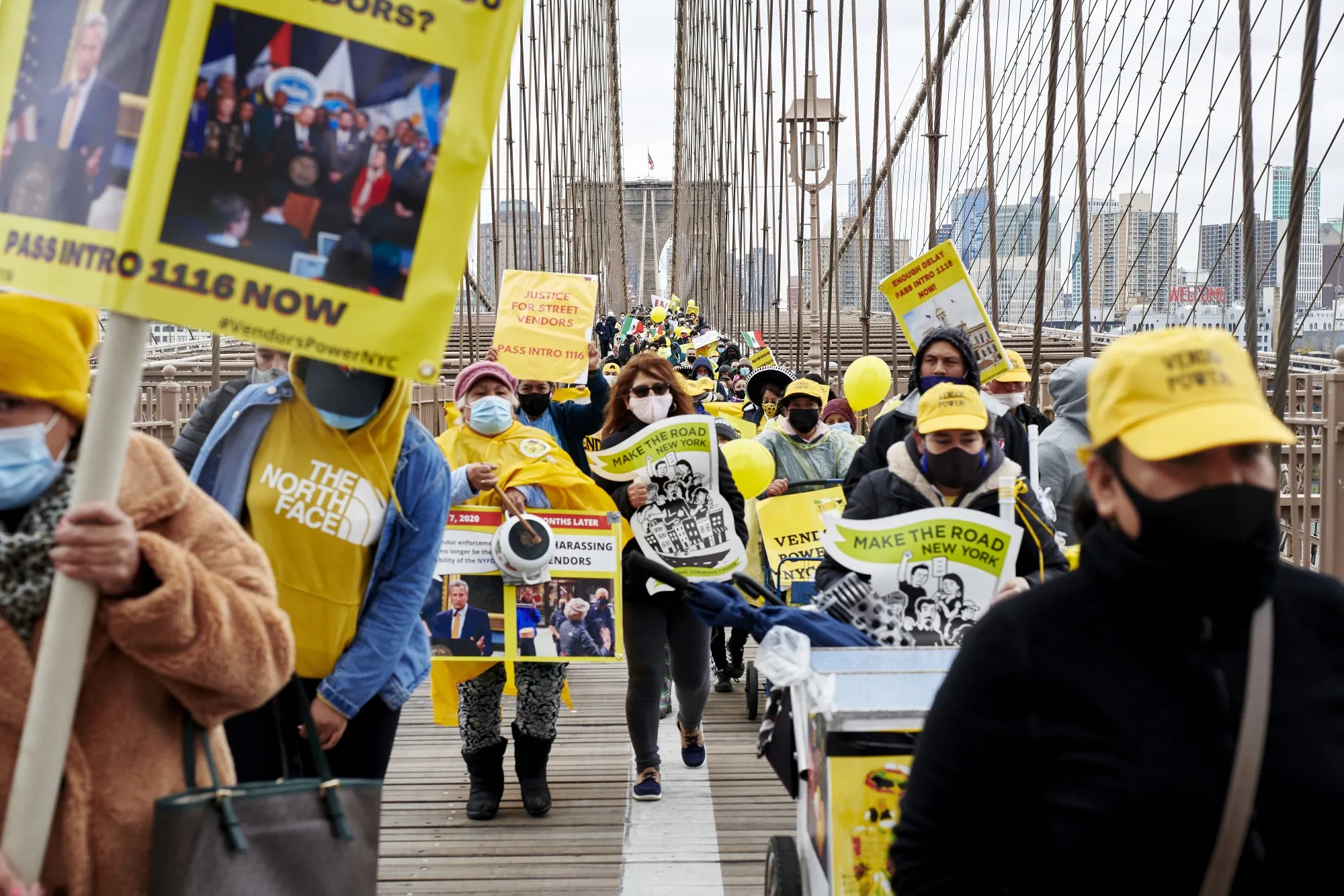 Street vendors and supporters march across Brooklyn Bridge during a rally on Nov. 12, 2020.