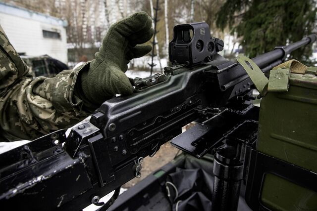 Members of the 242 Territorial Defense battalion are slicing and welding steel pipes to fit swivel mounts for machine guns on top of pickup trucks, oriented vertically to shoot down drones.