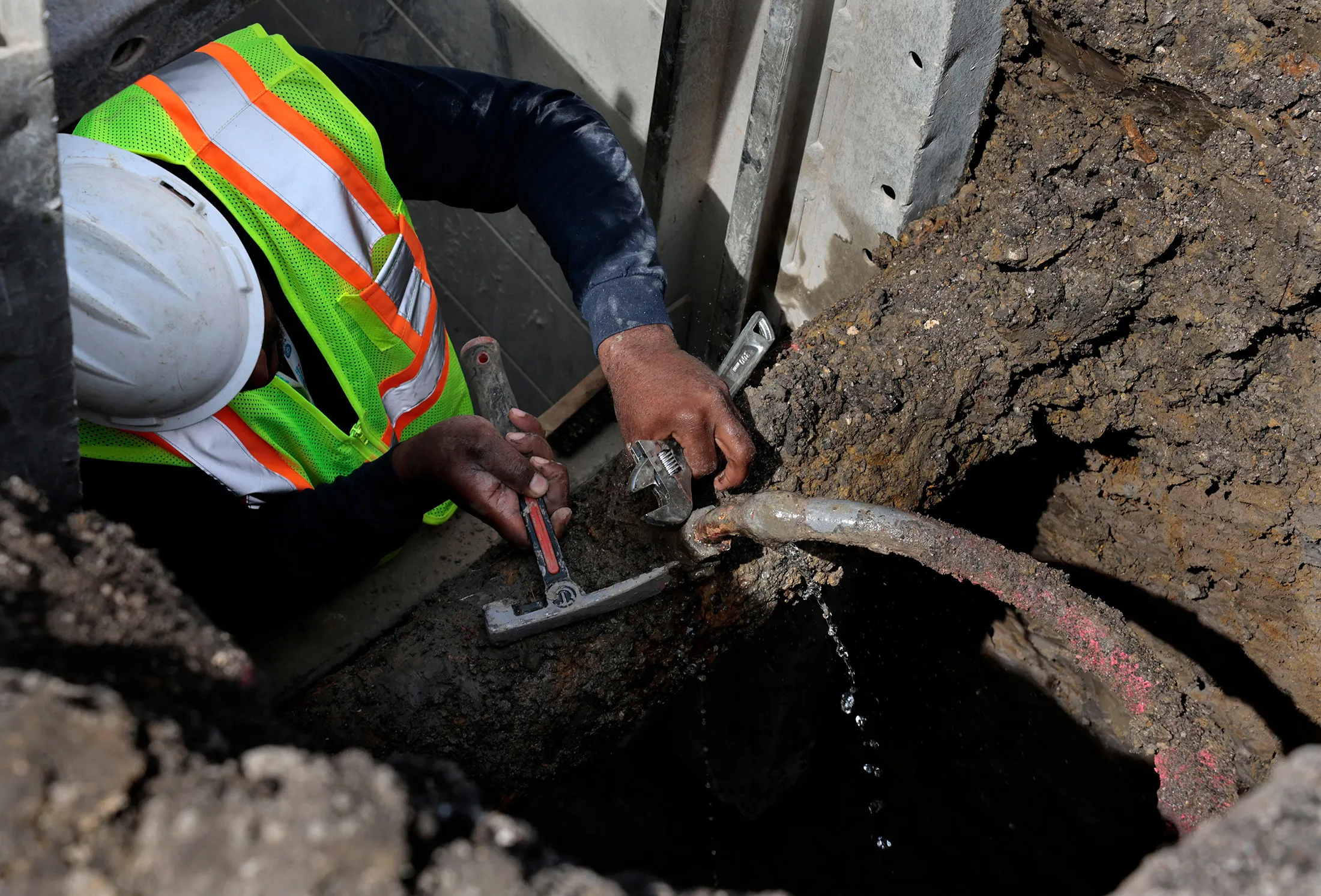A contractor fixes and closes off a leaking lead service pipe in Chicago on April 10, 2023. (Antonio Pere/Chicago Tribune/Tribune News Service via Getty Images)