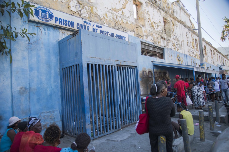 People wait to visit inmates at the prison in Port-au-Prince.