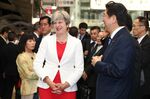 U.K. Minister Theresa May and her Japanese counterpart Shinzo Abe wait for their Shinkansen bullet train bound for Tokyo at Kyoto station on Aug. 30.

