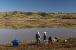 Fishermen along the shore of Nicasio Reservoir after a rainstorm in Nicasio, California, on Nov. 3, 2021.