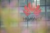 A Huawei Technologies Co. logo hangs above the entrance to the company's offices in Reading, U.K., on Monday, July 13, 2020. U.K. Prime Minister Boris Johnson is under pressure to announce a ban on telecoms companies from installing new equipment made by Huawei Technologies Co. in Britain's fifth-generation mobile networks from as soon as the end of 2021.