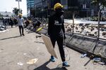 A demonstrator walks along a road blocked with barricades during a protest on Nov. 15.
