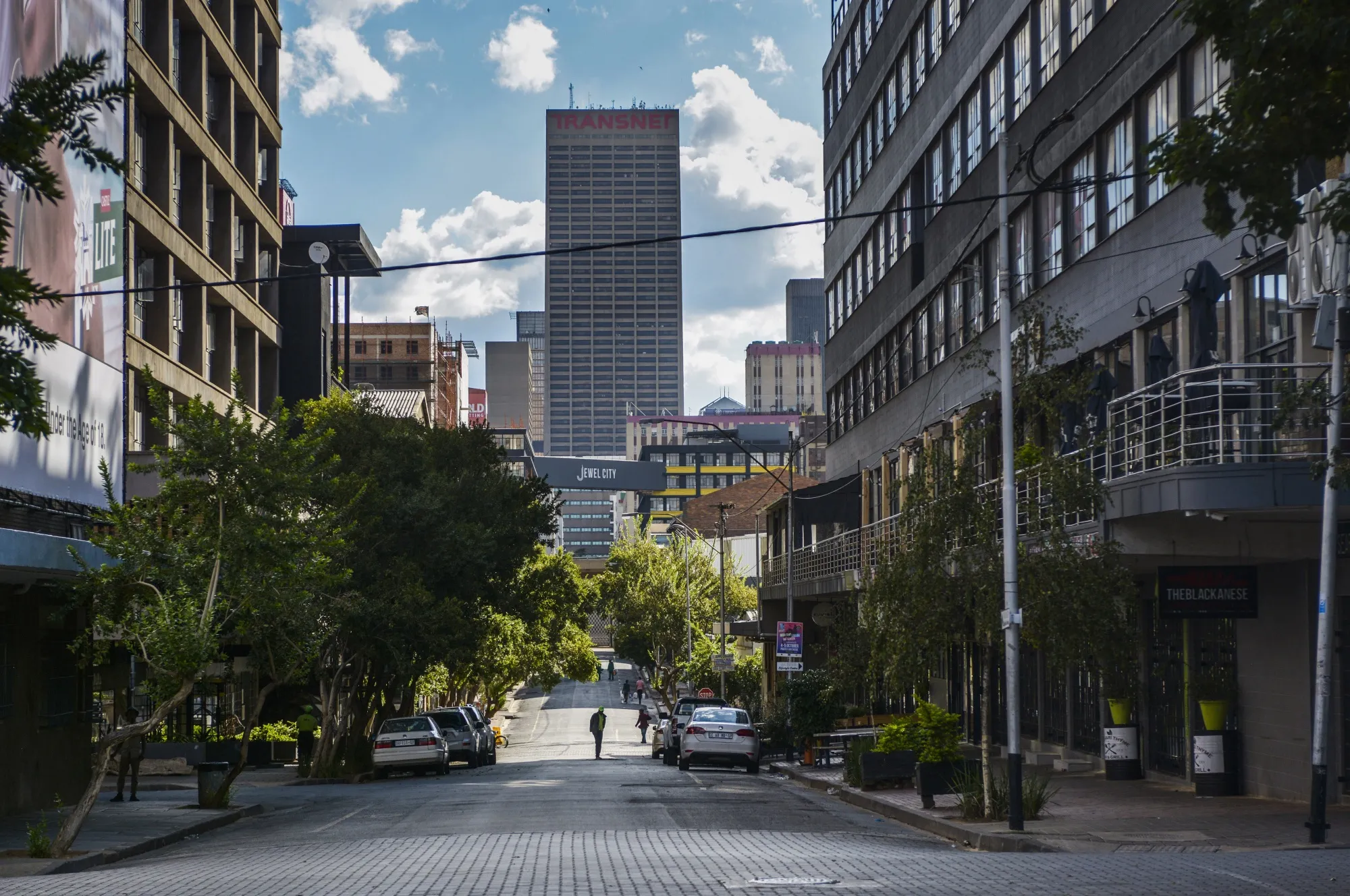 A pedestrian crosses a nearly empty street&nbsp;in the the Central Business District of Johannesburg on April 6.
