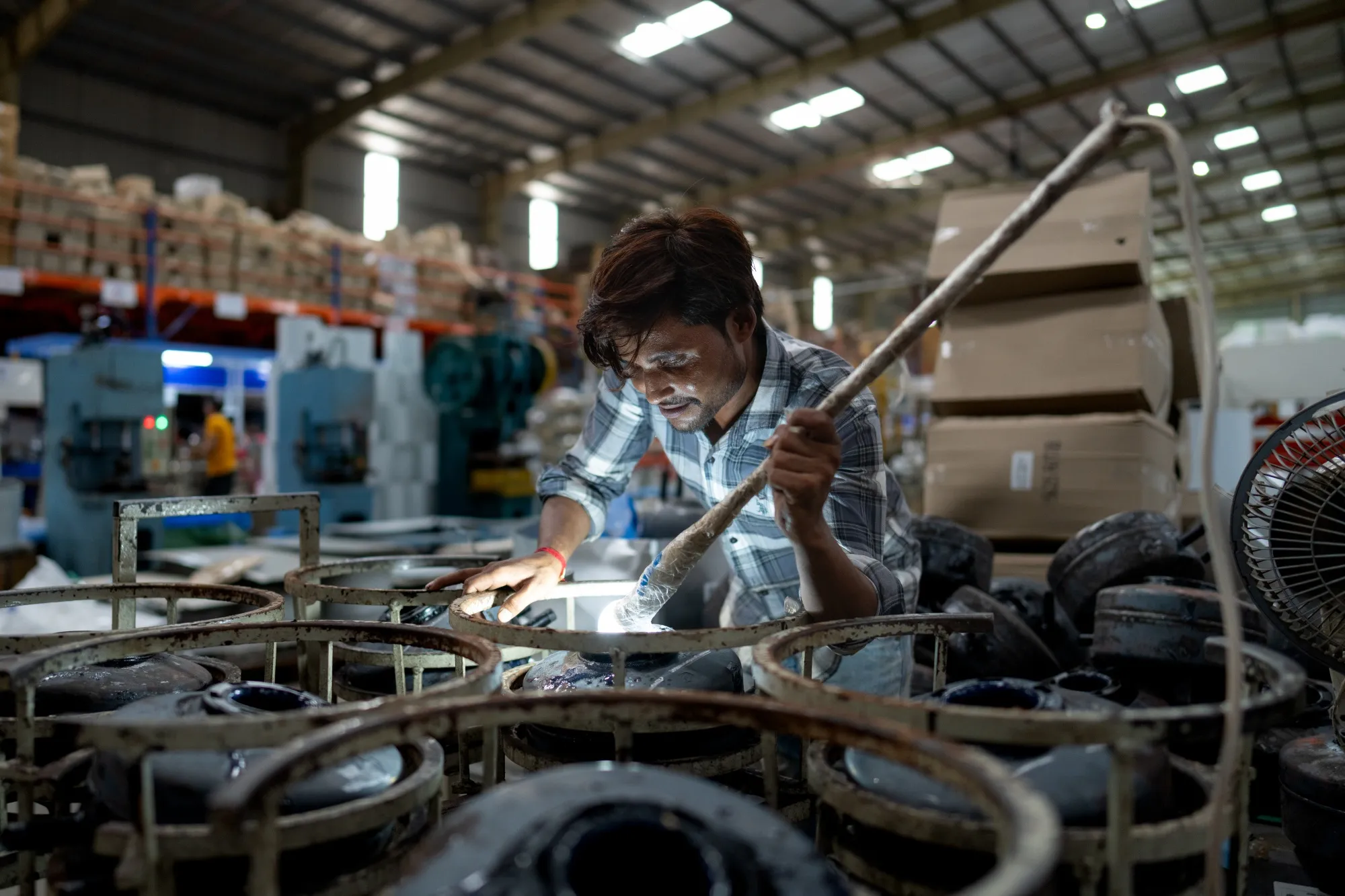 An employee on the production line of a factory producing water heaters in Sonepat, India.