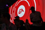Attendees stand&nbsp;in front of a Electronic Arts&nbsp;logo displayed on a screen during the company's EA Play event.