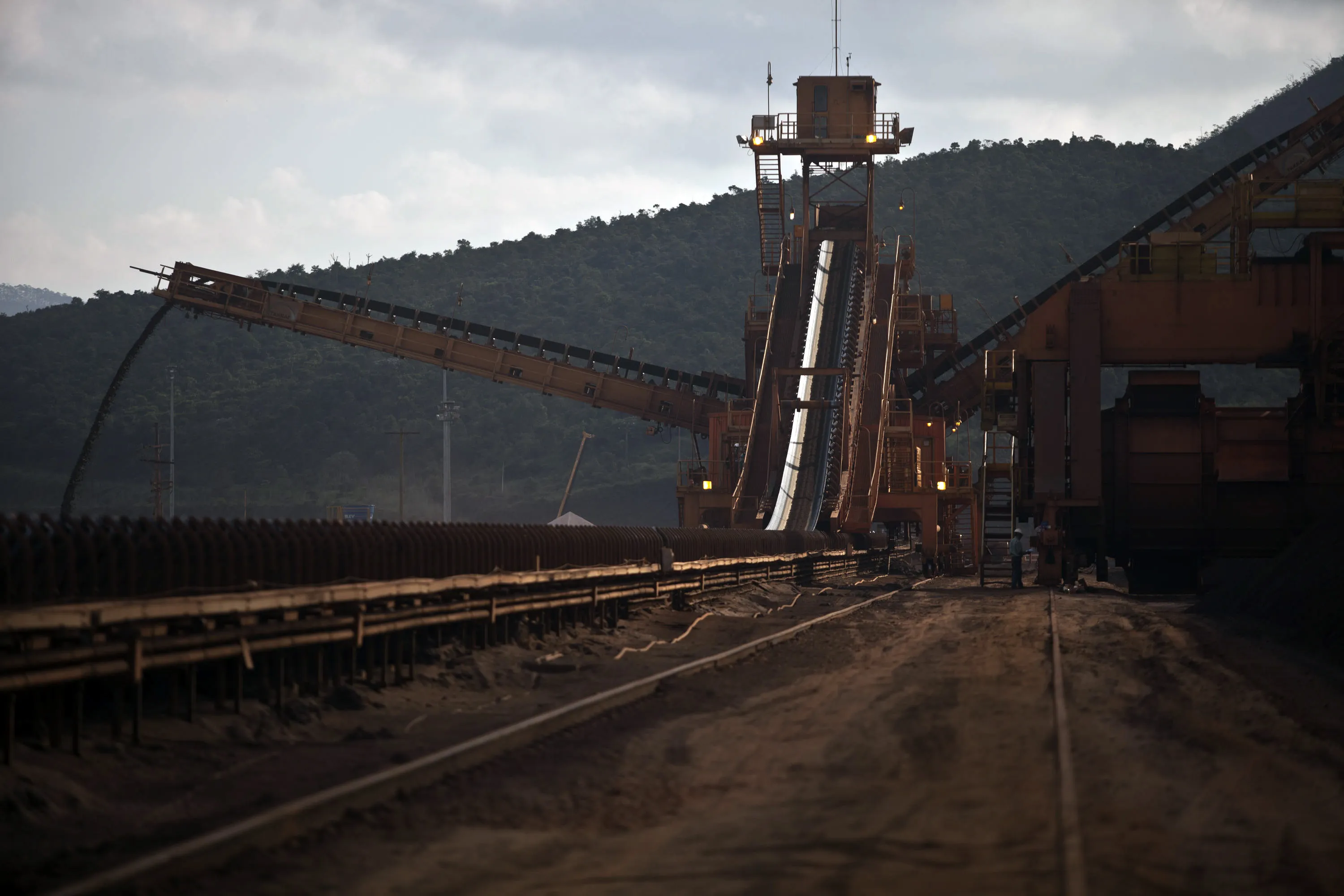 Crushed iron ore moves along a conveyer belt to be loaded into railroad cars at a Vale&nbsp;mine in Barao de Cocais, Brazil.