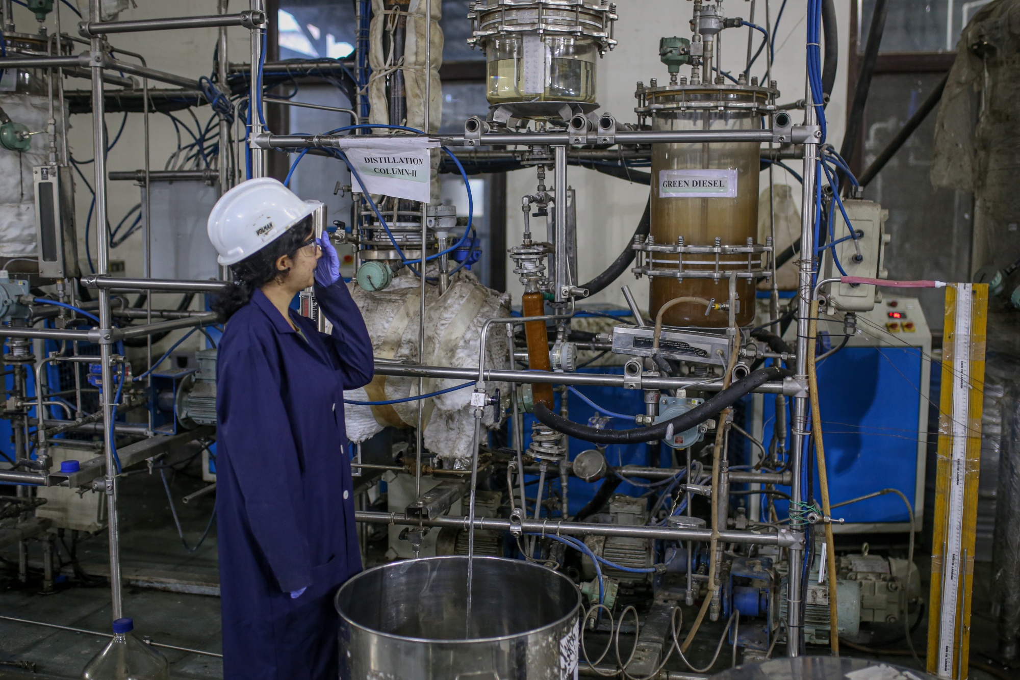 A worker observes the bio jet fuel production at The Council Of Scientific And Industrial Research-Indian Institute of Petroleum in Dehradun in Oct.