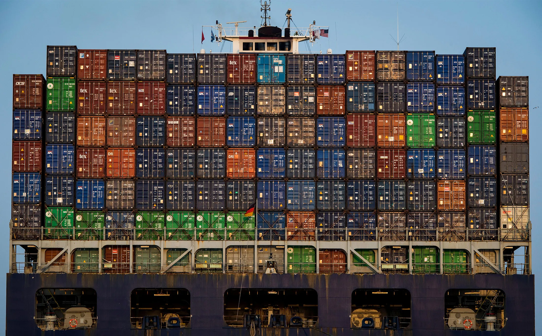 Shipping containers sit on a cargo ship sailing from the Port of Oakland in Oakland, California.