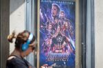 A pedestrian walks past an "Avengers: Endgame" poster at the Grand Lake theater in Oakland, California, U.S., on Monday, April 29, 2019. 