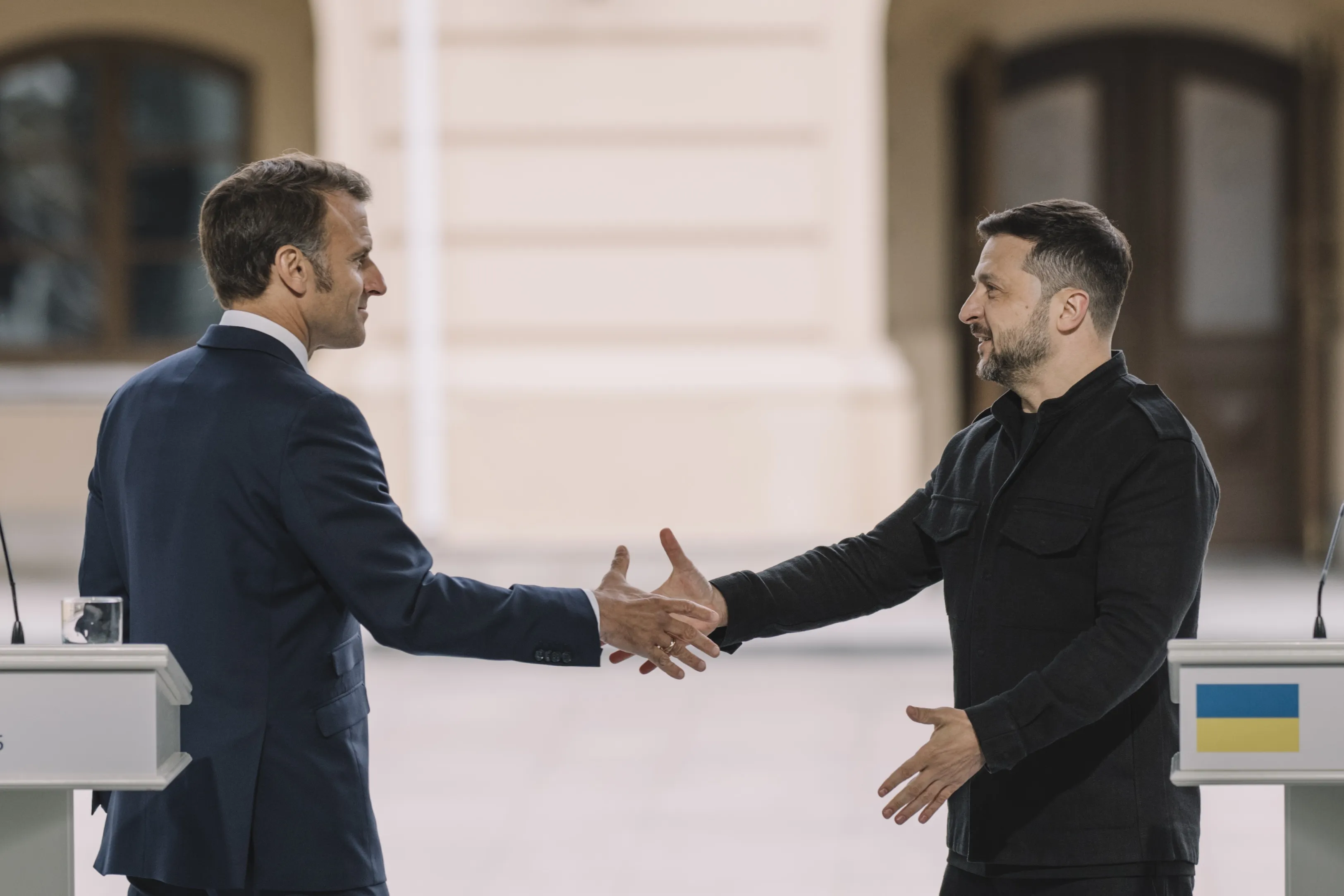 Emmanuel Macron, left, shakes hands with Volodymyr Zelenskiy, during a "Coalition of the Willing" news conference at in Kyiv, on May 10, 2025.&nbsp;